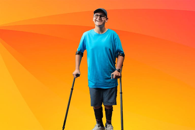 Smile man standing with assistive cane and lower leg support